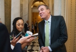 Sen. Mark Warner, D-Va., the Senate Intelligence Committee chairman, pauses to speak with reporters at the Capitol in Washington, June 10, 2021.