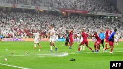 Fans throw bottles and flip-flops at the pitch during the 2019 AFC Asian Cup semi-final football match between Qatar and UAE at the Mohammed Bin Zayed Stadium in Abu Dhabi, Jan. 29, 2019.