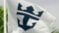 FILE - The Royal Caribbean Cruises Ltd., flag waves outside the headquarter building in Miami, Florida.