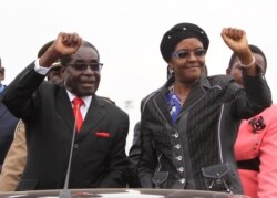 FILE - Then-president Robert Mugabe and his wife Grace wave to supporters and guests during celebrations to mark his 90th birthday in Marondera about 80km (50 miles) east of the capital Harare, Feb. 23, 2014.
