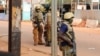 FILE - Junta soldiers stand guard in a street of Ouagadougou, Burkina Faso, Oct. 1, 2022.