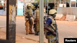 FILE - Junta soldiers stand guard in a street of Ouagadougou, Burkina Faso, Oct. 1, 2022.