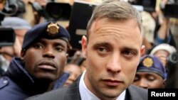 Olympic and Paralympic track star Oscar Pistorius leaves court after appearing for the 2013 killing of his girlfriend Reeva Steenkamp in the North Gauteng High Court in Pretoria, South Africa, June 14, 2016.