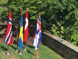 The flags of Nordic countries are on display at a concert at the Danish Embassy celebrating the 2019 Nordic Jazz Festival. (VOA/N. Liu)