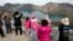 In this Saturday, Aug. 18, 2018, photo, Chinese tourists take in the sight from a viewing platform overlooking the caldera of Mount Paektu near Samjiyon in North Korea. 