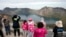 FILE - Chinese tourists take in the sight from a viewing platform overlooking the caldera of Mount Paektu near Samjiyon in North Korea, Aug. 18, 2018.