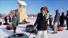 Nasrieen Habib, left, and Makiya Amin pull their snow tubes on top of a hill during an outing organized by the group Habib founded to promote outdoors activities among Muslim women, at Elm Creek Park Reserve in Maple Grove, Minn., Jan. 4, 2025.