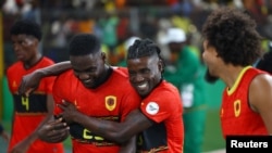 Angolan players celebrate after winning 3-0 against Namibia in the Round of 16 at the 2023 Africa Cup of Nations tournament, held in Abidjan, Ivory Coast, Jan. 27, 2024. 