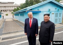 FILE - U.S. President Donald Trump meets with North Korean leader Kim Jong Un at the demilitarized zone separating the two Koreas, in Panmunjom, South Korea, June 30, 2019.