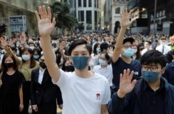 Demonstrators raise their hands as they attend a protest at the Central District in Hong Kong, Nov. 15, 2019.