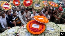 Local residents pay their respects to the victims of the attack at the Holey Artisan Bakery at a stadium in Dhaka, Bangladesh, July 4, 2016. 