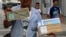 A street vendor offers unauthorized items for sale stamped with Olympic symbols and words along Copacabana beach in Rio de Janeiro, Brazil, July 28, 2016.