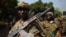A picture taken on January 10, 2013 shows Seleka rebel coalition members take up positions in a village 12 kilometers from Damara, where troops of the regional African force are stationed. 