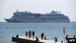 FILE - A cruise ship is pictured in the bay of the southeastern French city of Cannes, May 10, 2016.