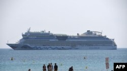 FILE - A cruise ship is pictured in the bay of the southeastern French city of Cannes, May 10, 2016.