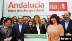 Andalusia's regional government acting president Susana Diaz (C) smiles as she gives a news conference with party members in the Andalusian capital of Seville, Spain, March 23, 2015. 