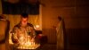 FILE— An Ukrainian serviceman of the 72nd Separate Mechanized Brigade, lights candles during a Christian Orthodox Easter religious service, in Donetsk region, Ukraine, May 4, 2024.