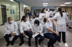Medical staff of a Dominican Republic military hospital in Santo Domingo, wait for their turn to be vaccinated against COVID-19 on Feb. 16, 2021.