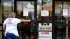 FILE - A hiring sign is displayed outside a retail store in Buffalo Grove, Illinois, June 24, 2021. 