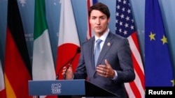 Canada's Prime Minister Justin Trudeau listens while addressing the final news conference of the G-7 summit in the Charlevoix city of La Malbaie, Quebec, June 9, 2018.