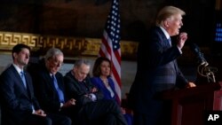 FILE - President Donald Trump, right, speaks on Capitol Hill in Washington, Jan. 17, 2018, as, left to right, Speaker of the House Rep. Paul Ryan, R-Wisconsin, Senate Majority Leader Sen. Mitch McConnell, R-Kentucky, Senate Minority Leader Sen. Chuck Schumer, D-New York, and House Minority Leader Rep. Nancy Pelosi, D-California, look on.