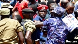 Ugandan opposition leader and singer Robert Kyagulanyi Ssentamu, known as Bobi Wine, is detained by riot-policemen during an anti-government demonstration in Kampala, Uganda, March 15, 2021.