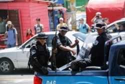 FILE - Police patrol outside the Central American University (UCA), where students are protesting to demand the release of political prisoners, in Managua, Nicaragua, June 18, 2019.