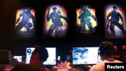 FILE - Gamers play Call of Duty: Black Ops 4 at a community reveal event in Hawthorne, California, May 17, 2018.