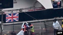 FILE—Migrants with children, some of the first in 2024 to be picked up at sea attempting to cross the English Channel from France, disembark from the UK Border Force Cutter 'Typhoon', at the Marina in Dover southeast England, on January 13, 2024.