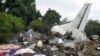 FILE - Responders pick through the wreckage of a cargo plane which crashed in the capital Juba, South Sudan Wednesday, Nov. 4, 2015. (AP Photo/Jason Patinkin)