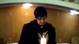 Winnie Madikizela-Mandela, ex-wife of former South African President Nelson Mandela, holds a candle during a prayer service for the ailing Mandela at a church in Johannesburg, July 5, 2013.&nbsp;