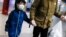 A child wears a protective mask and gloves in the subway system due to COVID-19 concerns, March 19, 2020, in New York.