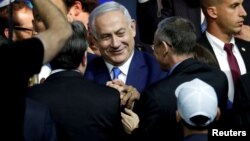 FILE - Israeli Prime Minister Benjamin Netanyahu is greeted by supporters of his Likud party as he arrives to speak following the announcement of exit polls in Israel's parliamentary election at the party headquarters in Tel Aviv, Israel, April 10, 2019.