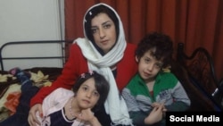 Narges Mohammadi, an Iranian human rights advocate, who is serving her jail term, is seen along with her two children in their home in Tehran.