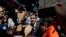 Supporters of opposition leader Juan Guaido and the press gather around him as he leaves a public plaza where he spoke in Caracas, Venezuela, Jan. 25, 2019.