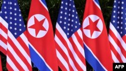 FILE - U.S. and North Korean flags stand side by side at the site of a summit between U.S. President Donald Trump and North Korea's leader Kim Jong Un, on Sentosa island in Singapore, June 12, 2018.