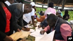 People fill out public participation forms at a forum for an impeachment motion against Kenya's deputy president Rigathi Gachagua, at Bomas of Kenya, in Nairobi, Oct. 4, 2024.