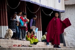 A young monk exiting the Buddhist Sera monastery in Lhasa on September 11, 2016. (Johannes Eisele/AFP)