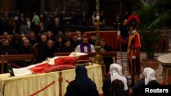 Faithful pay homage to former Pope Benedict in St. Peter's Basilica at the Vatican