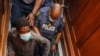 Zandile Christmas Mafe (L), a suspect in connection to a fire at the South African Parliament, appears in the Cape Town Magistrates Court in Cape Town on Jan. 4, 2022.