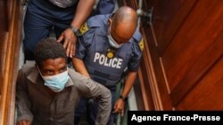 Zandile Christmas Mafe (L), a suspect in connection to a fire at the South African Parliament, appears in the Cape Town Magistrates Court in Cape Town on Jan. 4, 2022.