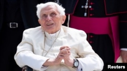 FILE - Pope Emeritus Benedict XVI gestures at the Munich Airport before his departure to Rome, June 22, 2020. 