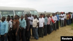 FILE - Former Nigerian militants queue to register at an arms collection center in Ogoloma-Okrika district, around 50 km (30 miles) east of the oil hub Port Harcourt. 