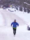 Radnik čisti sneg sa stajalištu piste na aerodromu Detroit Metropolitan Detroit Metropolitan Wayne okrugu u Romulusu, Michigan, 6. januara 2025.