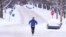 Un hombre corre por una calle cubierta de nieve en Indianápolis, Indiana, el lunes 6 de enero de 2025. AP