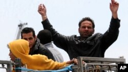 Migrants, some of the more than 4,000 rescued by the Italian coast guard since Friday, wait to disembark from the Irish naval ship Le Eithne, at the Palermo harbor, Italy, May 30, 2015. 