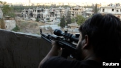 A Free Syrian Army sniper looks through the scope of his rifle at an area controlled by forces loyal to Syria's President Bashar al-Assad in Aleppo' September 11, 2013.Analysts say the FSA lacks effective leadership.