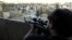 A Free Syrian Army fighter looks through the scope of his sniper rifle at an area controlled by forces loyal to Syria's President Bashar al-Assad in Aleppo's Al-Ezaa neighborhoo,d Sept. 11, 2013.