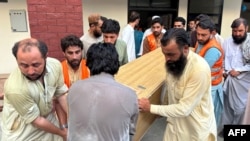 People carry the coffin of former Senator Hidayatullah Khan after he was killed in a bomb explosion in the Bajaur district of Pakistan's Khyber Pakhtunkhwa province on July 3, 2024.