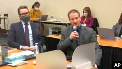 In this image from video, defense attorney Eric Nelson, left, and defendant Derek Chauvin address Hennepin County Judge Peter Cahill during motions before the court, April 15, 2021, in Chauvin's trial in Minneapolis.